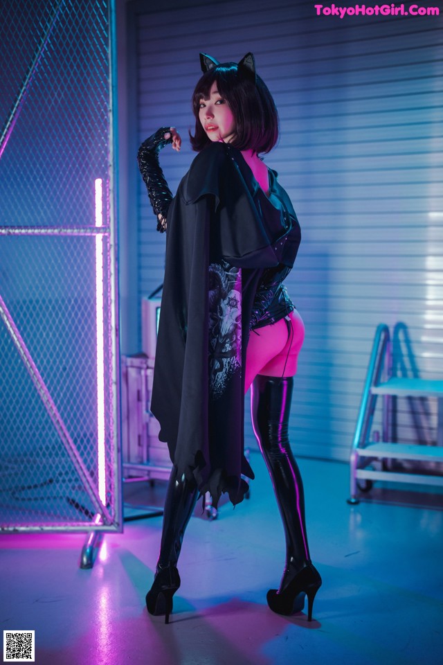 A woman in a black cat costume posing for a picture.