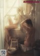 A naked woman sitting in a bathtub next to a window.