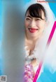 A woman in a wedding dress holding a bouquet of flowers.